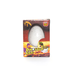 Retail packaging for the Giant Growing Dino Egg toy.  A white speckled egg sits in a cardboard box that depicts baby dinosaurs hatching.