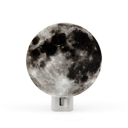 A moon night light. The night light has a circular cardboard cutout of the lunar surface in front of the night light bulb so that the moon will light up when the light is turned on.